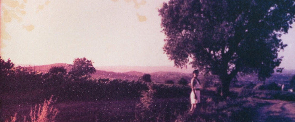 hazy memories from a summer in france, a female figure looks back at the camera with no sign of intent